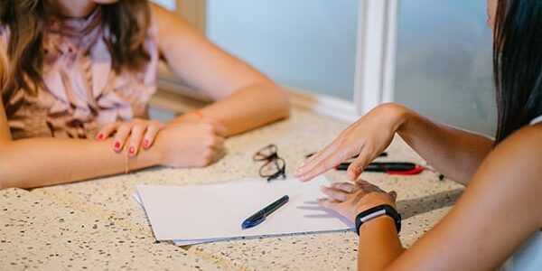 women meeting talking over papers